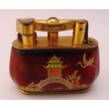 A Dunhill chinoiserie style table lighter decorated with oriental pavilions and bridges
