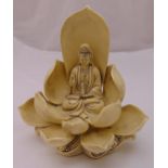 A Dehua Guanyim figurine seated on a stylised lotus throne, 31cm (h)