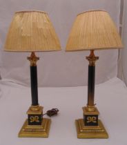 A pair of gilt metal and enamel Corinthian column table lamps on raised square bases with