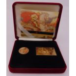 2001 gold sovereign and a gilded silver gilt stamp ingot in presentation packaging