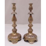 A pair of Russian hallmarked silver table candlesticks, the knopped stems chased with stylised
