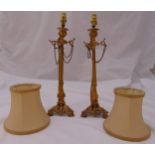 A pair of Victorian ormolu candlesticks of tapering cylindrical form on pierced trifom base with