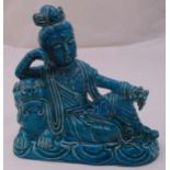 A Chinese turquoise glazed figurine of Guanyin seated with a lion, marks to the base, 24 x 25cm