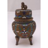 An early 19th century Chinese tea caddy of globular form, the raised pull off cover with lion finial