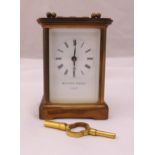 Matthew Norman brass carriage clock of customary form, white enamel dial and Roman numerals, to