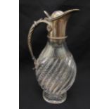 A Victorian cut glass claret jug, compressed oval ribbed form on raised oval base, scroll handle and
