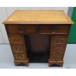 A mahogany rectangular kneehole desk with eight drawers and tooled leather top, 76 x 77.5 x 51cm