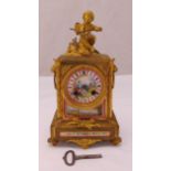 A French 19th century mantle clock, gilded metal and porcelain panels depicting courtly scenes,