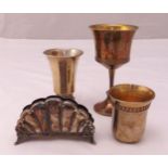 A quantity of white metal to include three Kiddush cups and a napkin holder