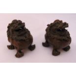 A pair of Chinese bronze incense burners in the form of stylised temple lions with hinged mask