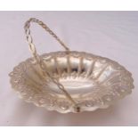 A Victorian hallmarked silver shaped oval nut dish with swing handle, London 1884 by Martin and