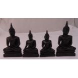 Four oriental carved wooden meditating Buddhas on raised shaped rectangular bases, 16.5cm (h)