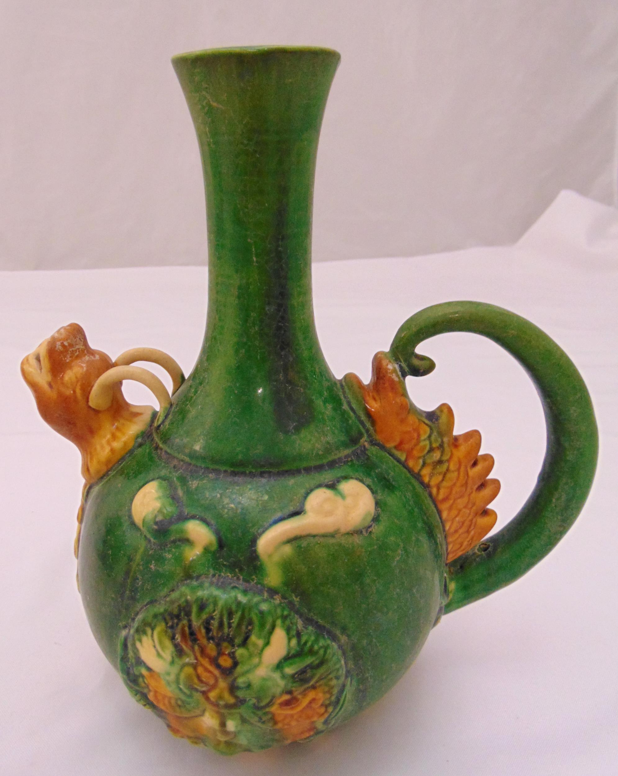 A Chinese Sancai pottery ewer with loop handle and lion mask spout, 25cm (h)