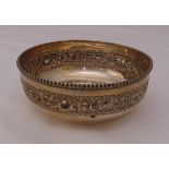 An Indian white metal bowl with embossed border