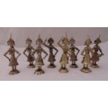 A set of eight white metal eastern figurines in various dance poses on raised circular bases,
