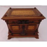 A continental rectangular carved wooden jewellery casket with hinged cover to reveal fitted