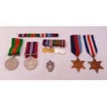 A quantity of WWII military medals with ribbons to include miniatures