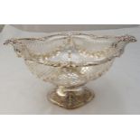 A hallmarked silver shaped oval and pierced fruit stand with floral and leaf border on raised