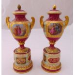 A pair of Vienna vases with gilded side handles, the sides decorated with classical panels, the