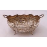 A Victorian hallmarked silver bonbon dish shaped oval with two handles on four legs, Glasgow 1895,