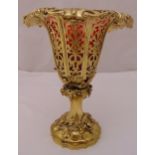 A Victorian silver gilt table centrepiece with red glass liner, scroll pierced vase form with