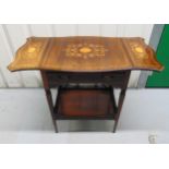 An Edwardian rectangular mahogany two tier table with drop flap sides on tapering rectangular