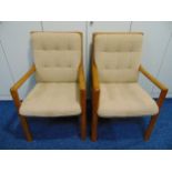 A pair of 20th century teak upholstered armchairs