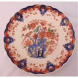 An early 20th century Delft charger decorated with flowers and leaves, 31cm (d)