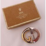 A vintage Gucci belt buckle in original Gucci packaging