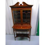 An Edwardian rectangular mahogany inlaid glazed display case with swan neck pediment above glazed