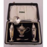 A cased hallmarked silver condiment set, Sheffield 1949 by Edward Viner and hallmarked silver sifter