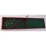 A Victorian hinged mahogany desktop table bar billiards set to include balls and a cue