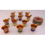 A set of twelve Vienna cabinet cups and saucers decorated with Rococo roundels, the cups on four