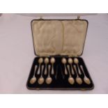 A cased set of hallmarked silver coffee spoons and a pair of sugar tongs, Sheffield 1944, approx