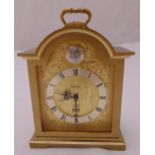 Swiza gilt metal mantle clock with Roman numerals, carrying handle on four bracket feet, 16cm (h)