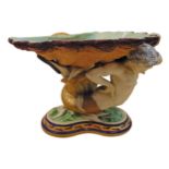 A 19th century Majolica centre piece in the form of a merman supporting a shell shaped dish on