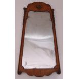 A 19th century rectangular wall mirror in walnut frame decorated with shells and drop husks, with