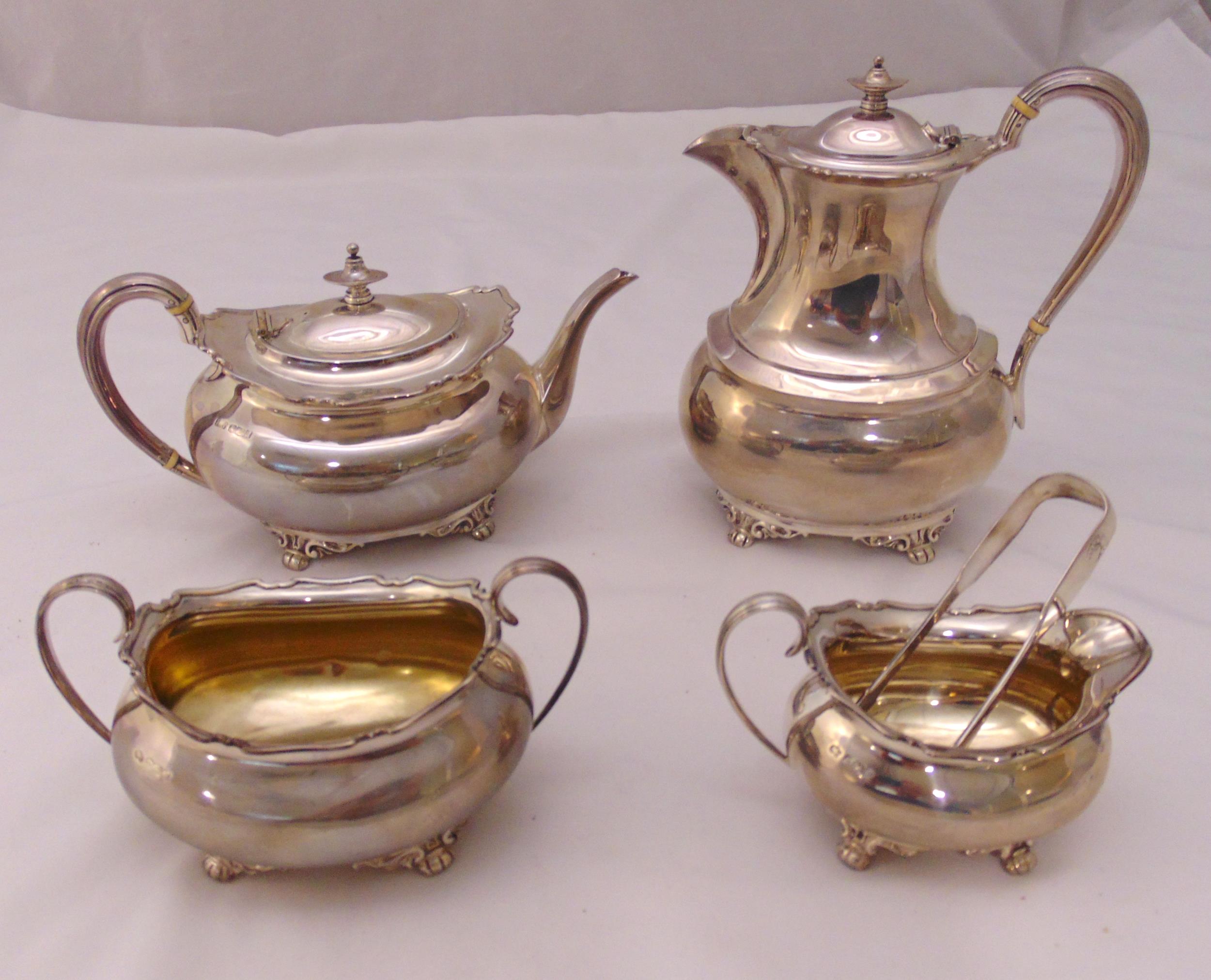 A hallmarked silver four piece teaset and a pair of sugar tongs of rounded rectangular form, the