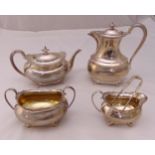 A hallmarked silver four piece teaset and a pair of sugar tongs of rounded rectangular form, the