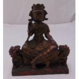 A Chinese bronze seated Buddha with stylised lions to either side, 23cm (h)