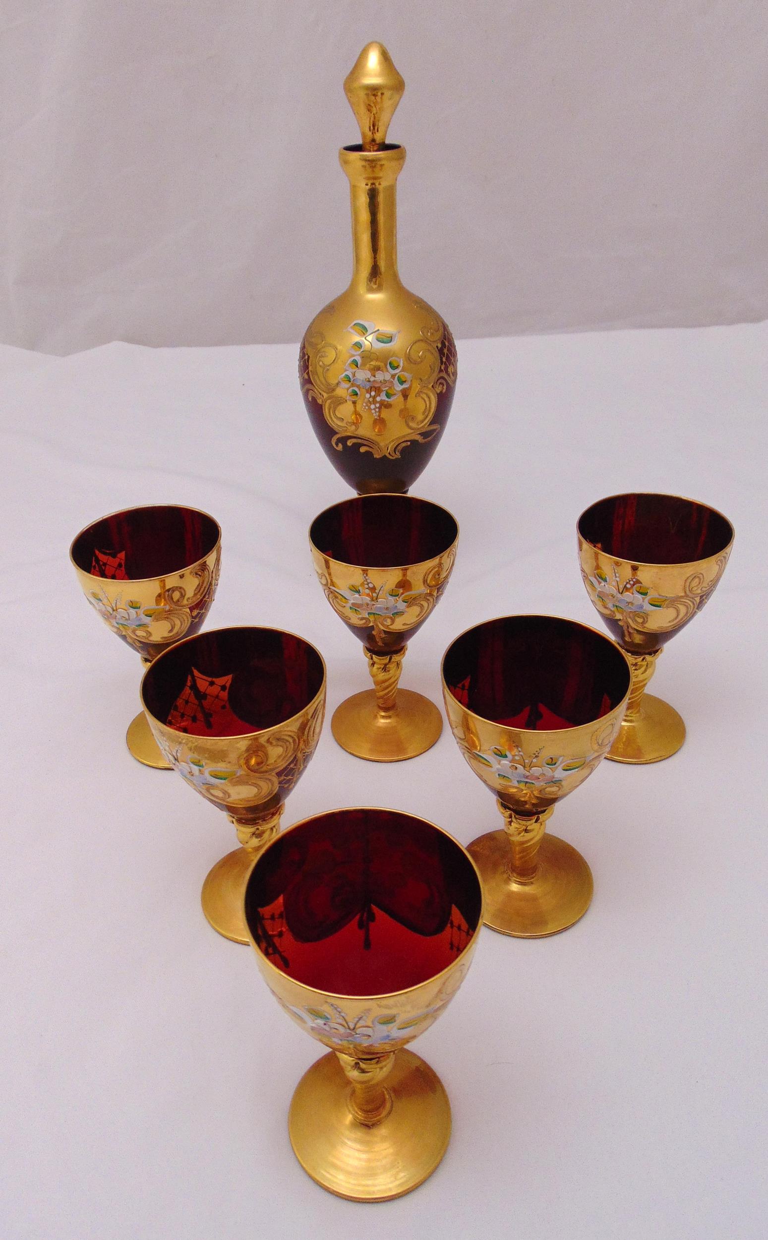 Murano glass decanter and six matching glasses decorated with applied flowers and gilded rims and