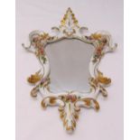 A Capodimonte porcelain wall mirror, shield shaped with applied floral decoration, 49 x 33.5cm