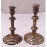A pair of hallmarked silver table candlesticks, knopped cylindrical stems on raised circular