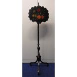 A Victorian papier mâché fire screen decorated with flowers and leaves, the cylindrical stand on