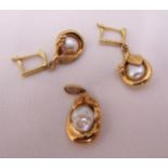 A pair of 9ct gold earrings and matching pendant