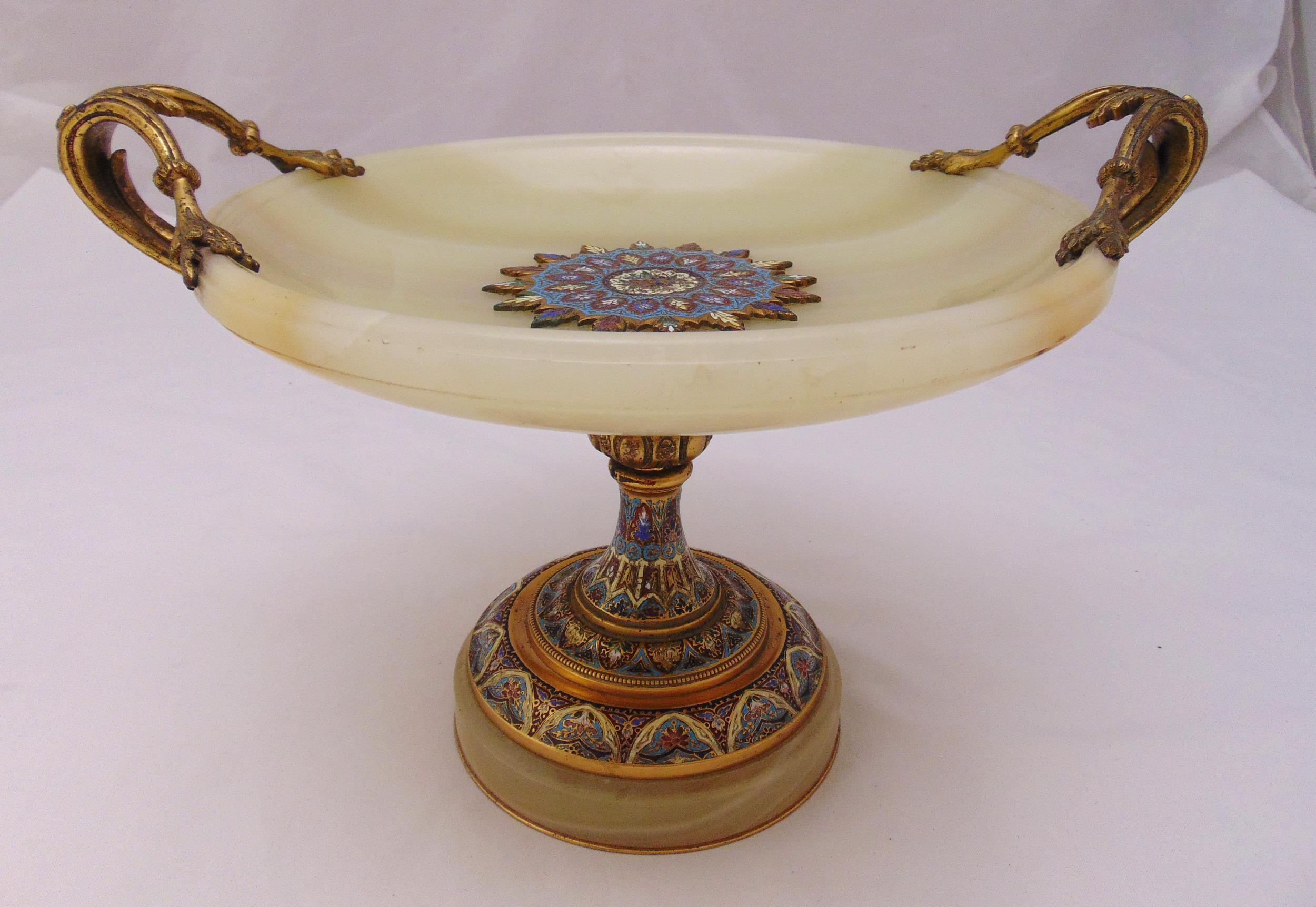 A late 19th century French onyx, champlevé and gilt metal tazza with leaf scroll side handles on