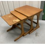 A mid 20th century nest of three rectangular teak stacking tables, tallest 50 x 56 x 44.5cm