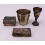 A quantity of white metal to include a Kiddush cup, a beaker, a napkin ring and a covered box (4)