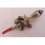 A 19th century silver child rattle with suspensory bells and coral mouth piece