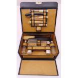 A gentlemans leather grooming travel case, fitted with glass and white metal containers and